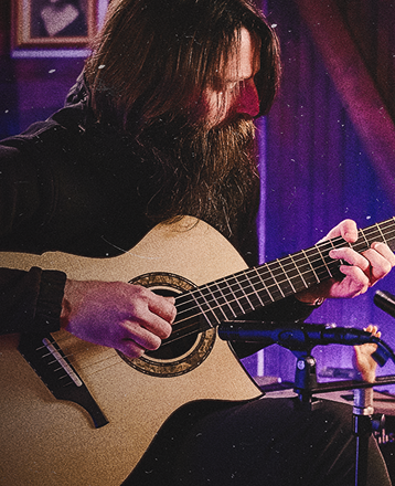 Matt Chulka Playing an Acoustic Guitar
