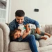 Dad and child playing with Sensi Touch 2 on wall