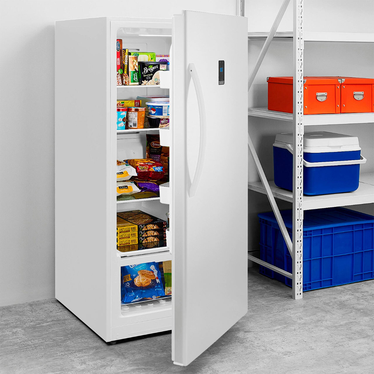 Open stocked refrigerator in garage