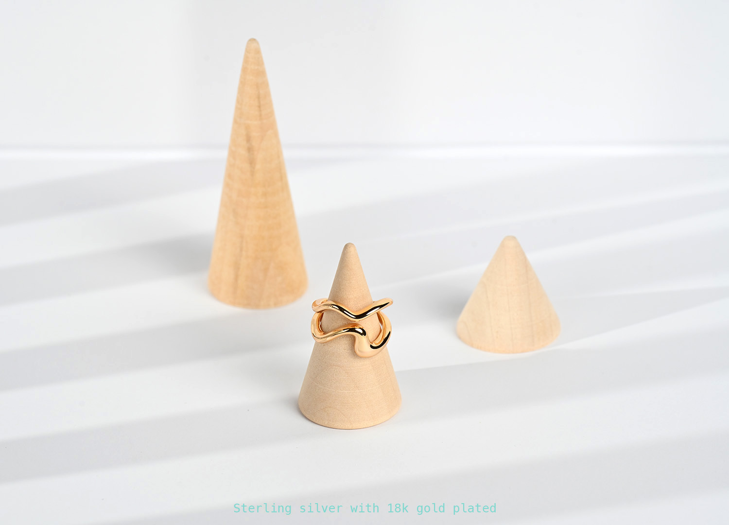 Close-up: Muriwai Beach ring texture - gold-plated surface mimics the reflection of mountain in the sea