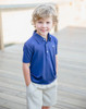 Little boy wearing Offshore Performance Polo, made with the softest performance fabric for summer fun