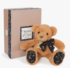 Baby cuddling Doudou’s soft, luxurious French-designed classic stuffed teddy bear, showcasing safety and comfort