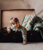 Little adventurer in Jungle Pyjamas, surrounded by the allure of roaring tigers and vivid foliage.