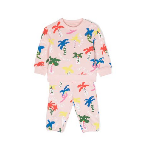 Child in pink tracksuit with colorful palm trees and positive phrases by Stella McCartney Kids.