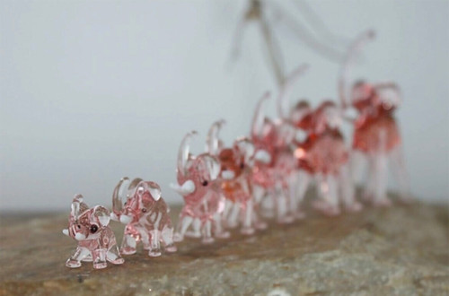 The lucky glass elephants displayed in an elegant setting, radiating charm and auspicious vibes. The lucky glass elephants displayed in an elegant setting, radiating charm and auspicious vibes.