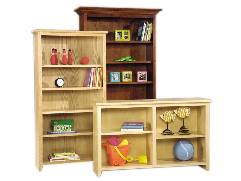 Assorted size Shaker Collection bookcases shown. Available in Oak or Birch in all of the Bedroom Source stains, paints and distressed finishes. Optional crown moulding pictured on the tallest bookcase. Note the low bookcase has a center divider with adjustable shelves each side. That is a standard feature of a 48" wide bookcase to keep the shelves from bowing.