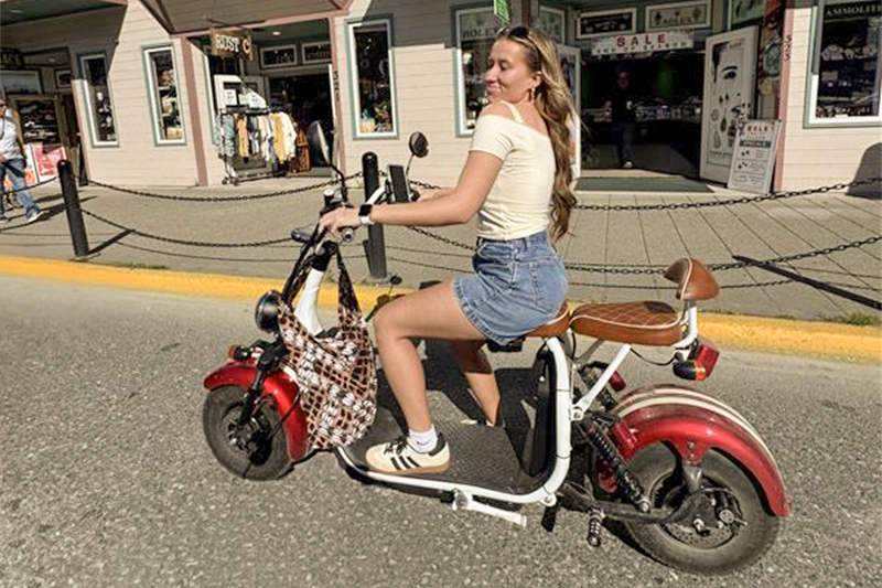 man and son riding a scooter