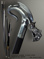 Exclusive walking cane Dragon with Skull in a jaws is created and produced in the USA. Somebody using a walking stick might want not only physical support, but also some level of collectible or self-defense value. That is why a support walking canes can be done as a sword cane or cane gun. In this case high quality knife or air gun shooting mechanism will be built into the shaft as shown on the picture. Artistic walking sticks handle is cast from sterling silver or bronze and mounted on the ebony or rosewood shaft. Custom version can be finished with natural gems.
