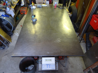 We use a 54" x 96" flat steel (5500#) table to perform any chassis set-up work