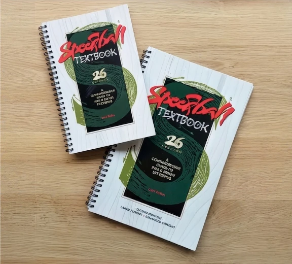 Speedball 26th Edition with curved calligraphy letterforms in the background