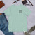 Try, Care, Feel in a small tee, Heather Prism Dusty Blue-ish Green