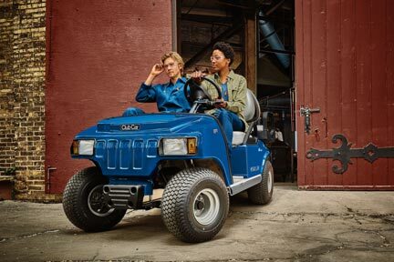 Club Car Carryall 100 in Blue with Passengers