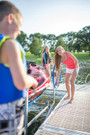 ShoreMaster 1200 PWC lift installed beside residential dock holding a Sea-Doo