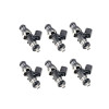Set of six Injector Dynamics ID1050X fuel injectors, angled view showing top connectors and lower nozzle tips.