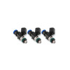 Set of three Injector Dynamics 1050-XDS fuel injectors, angled view showing blue tops, black bodies, and green O-rings.