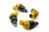 Set of four DeatschWerks 740cc side feed fuel injectors with yellow connectors, arranged in a circle.