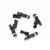 Four DeatschWerks 1000cc EV14 fuel injectors with black connectors, arranged in a circle, top view