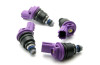 Set of four DeatschWerks 550cc side feed injectors, purple tops, black bodies, top down angled view