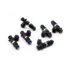 Set of six Deatschwerks 1250cc Bosch EV14 fuel injectors, black bodies with blue O-rings, top view.