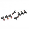 Set of eight Deatschwerks EV14 1250cc fuel injectors, angled view showing electrical connectors and O-rings.