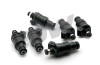 Set of six DeatschWerks 550cc top feed fuel injectors for RB26DETT, showing connectors and nozzle ends.