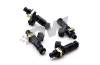Set of four DeatschWerks EV14 1200cc fuel injectors, angled view showing black bodies and top connectors.