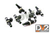 DeatschWerks EV14 1500cc top feed injectors, set of six, angled view showing black bodies and green O-rings