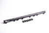 Radium Engineering Toyota 2JZ-GE fuel rail, angled view, black anodized finish with six injector fittings beside it