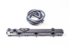 Radium Engineering fuel rail for Honda S2000, black billet bar with injector bungs and coiled hose beside it