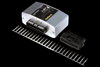 Haltech HPI4 Elite igniter unit shown at an angle with connector plug and pin set laid out beside it