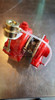 Red Honda Aquatrax turbocharger, top angle, showing wastegate actuator, hose fitting, and mounting flange