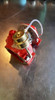 Honda Aquatrax turbocharger, red housing, brass wastegate actuator, top angled view on metal bench