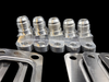 Turbo Gasket Shop Kit, five AN fittings on machined blocks lined up beside flat steel gaskets