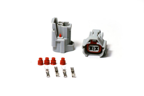 Injector Dynamics Denso female connector kit with two gray housings, red seals, and pin terminals
