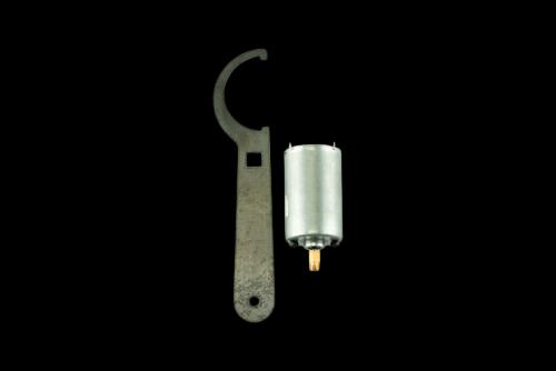 Turbosmart eStraight Gate Replacement Motor with spanner wrench tool, cylindrical body and gold connector pins shown.