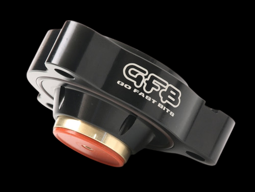 GFB DV+ diverter valve shown at an angle, black body with GFB logo, orange and brass piston visible