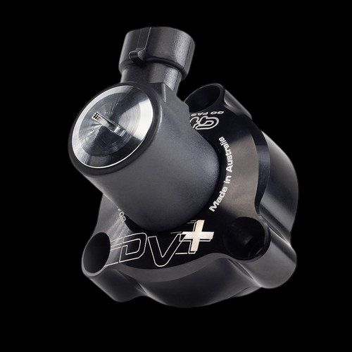 GFB DV+ diverter valve, angled view showing inlet port, piston housing, and DV+ logo on black body