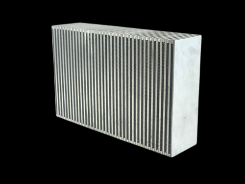 CSF Nissan GT-R R35 bar and plate intercooler core, angled view showing dense fin rows and bare aluminum end tank