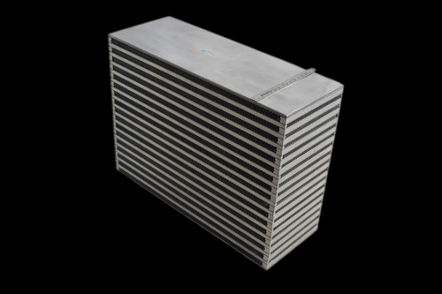 CSF Magnum bar and plate intercooler core, angled view showing stacked cooling fins and side tanks.