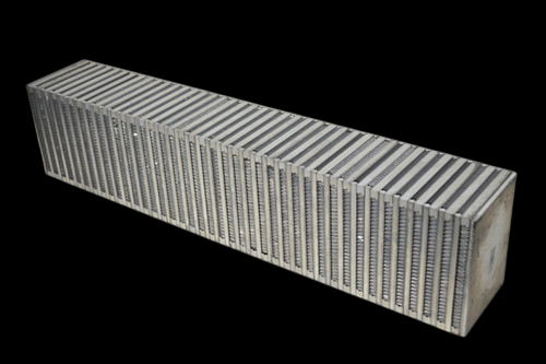 CSF vertical flow bar and plate intercooler core, angled view showing dense fin rows and end tanks.