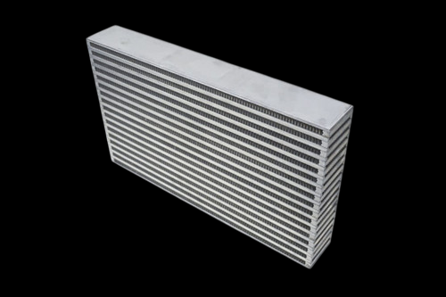 CSF bar and plate intercooler core, angled view showing louvered fins and end tank on black background