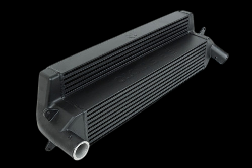 CSF stepped core intercooler in black, angled view showing finned core, end tanks and inlet outlet pipes.