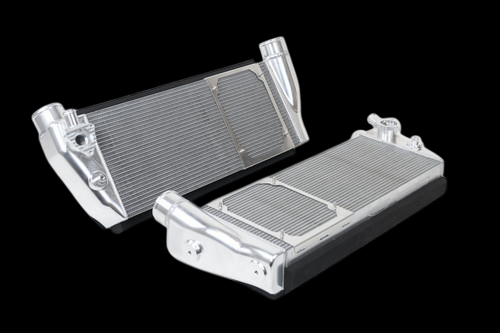 CSF Ferrari 488 GTB/Spider/Pista intercooler pair, raw aluminum, angled view showing end tank fittings and core fins