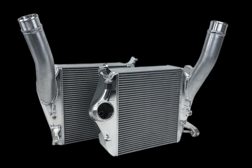 CSF Audi SQ7/SQ8 intercooler pair, raw aluminum finish, front angle with curved end pipes visible.