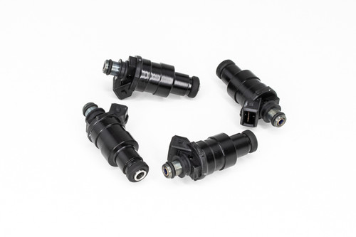 DeatschWerks 1200cc fuel injectors, set of 4, black bodies with electrical connectors, top down angle on white background