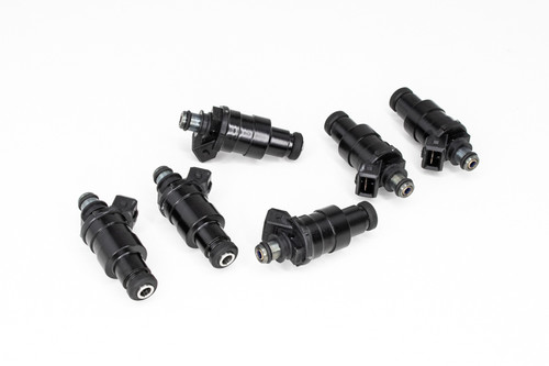Set of six DeatschWerks 1200cc low impedance fuel injectors, black bodies with fittings, arranged on white background.