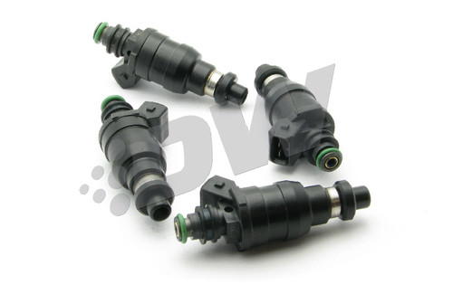 Set of four DeatschWerks 800cc top feed fuel injectors, black bodies with green O-rings, angled view