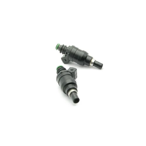 Two DeatschWerks 1000cc top feed fuel injectors for RX7 FC 1.3t, black bodies with green O-rings, angled view