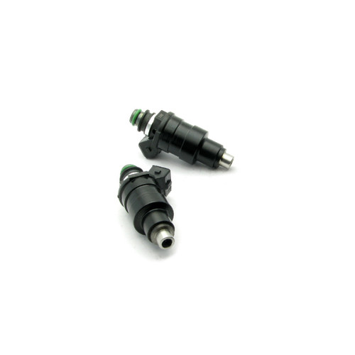 Two DeatschWerks 1200cc top feed fuel injectors for RX7 FC 1.3t, angled view showing green O-rings and nozzle tips.
