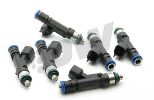 Set of six DeatschWerks 550cc top feed fuel injectors, black bodies, blue tops, angled overhead view showing connectors and O-rings.